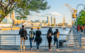 Tourists enjoying the view of Puente de la Mujer in Puerto Madero, Buenos Aires.