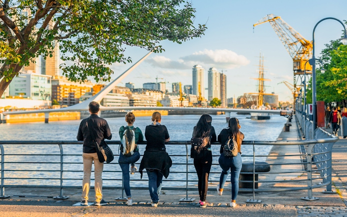 Tourists enjoying the view of Puente de la Mujer in Puerto Madero, Buenos Aires.