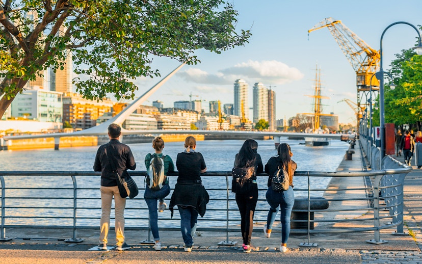 Tourists enjoying the view of Puente de la Mujer in Puerto Madero, Buenos Aires.