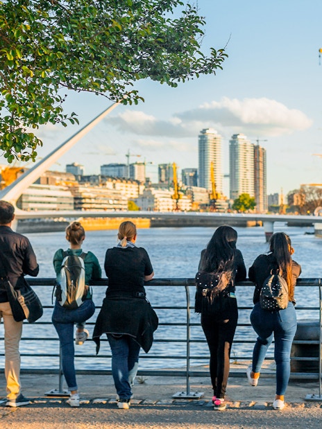 Tourists enjoying the view of Puente de la Mujer in Puerto Madero, Buenos Aires.