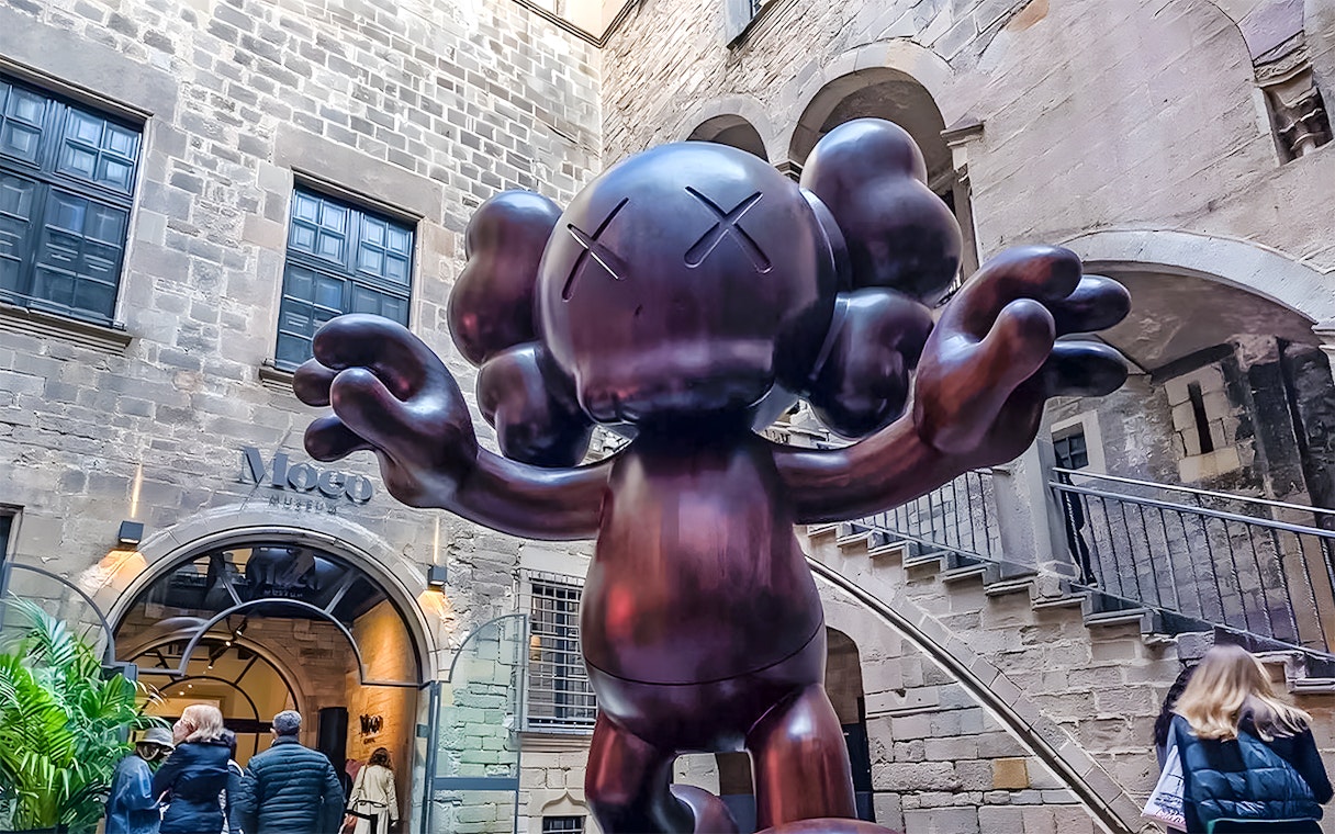 Sculpture by KAWS at Moco Museum entrance in Barcelona.