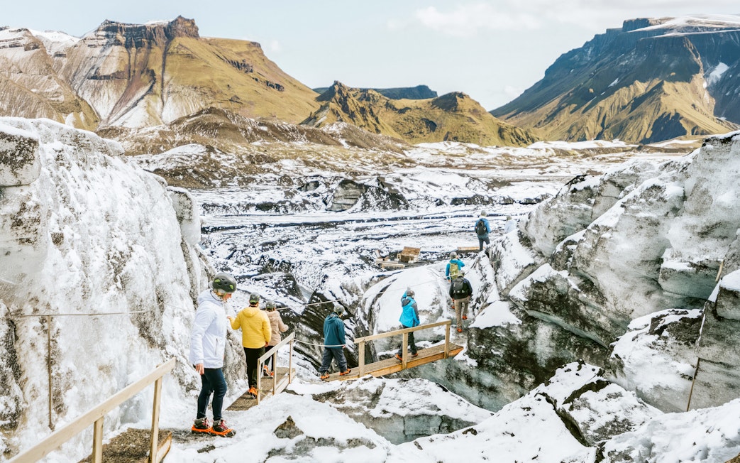 Tourists hiking through Katla Ice Cave in Kötlujökull glacier, Iceland.