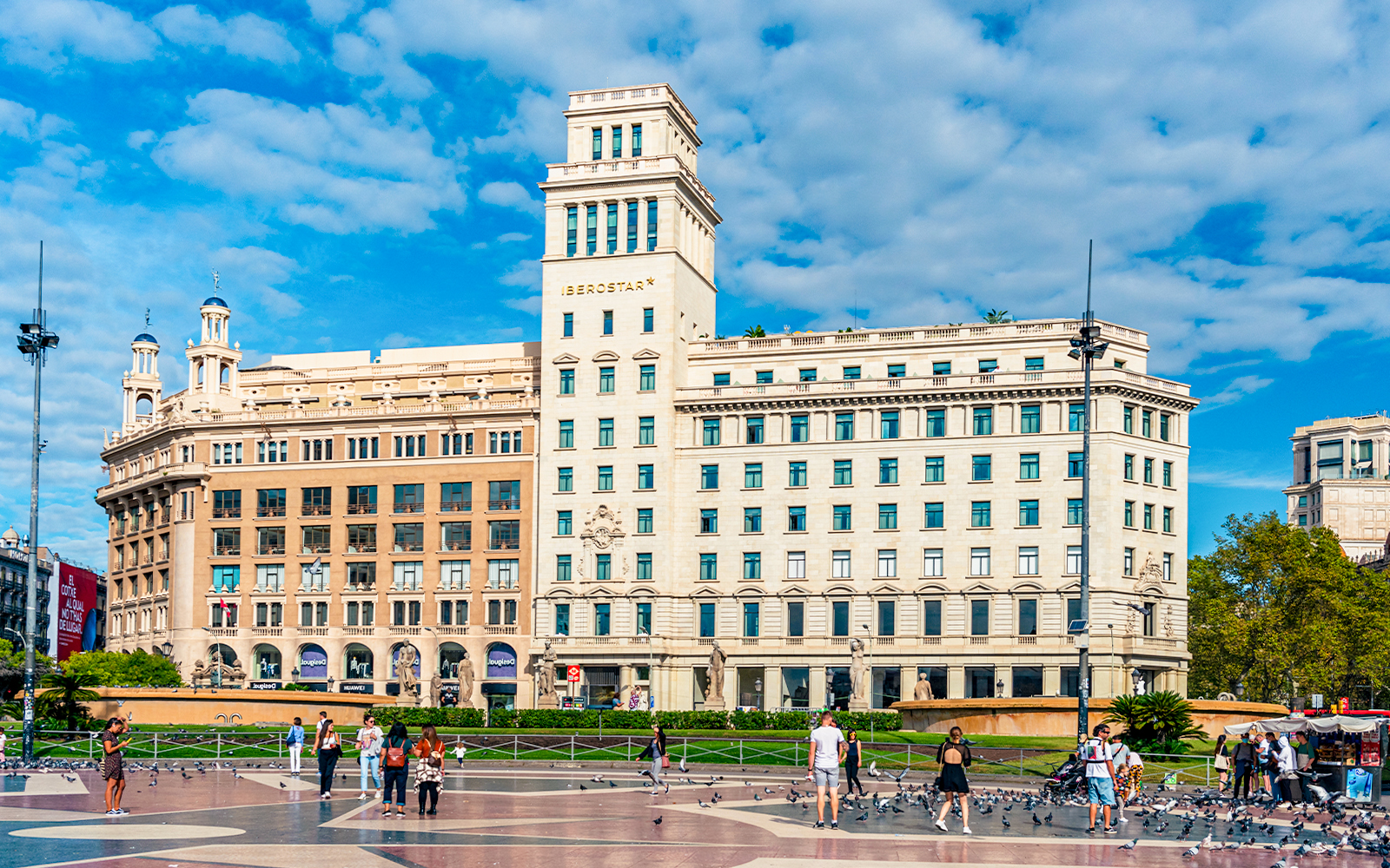 Placa de Catalunya Barcelona bustling square with people and pigeons.