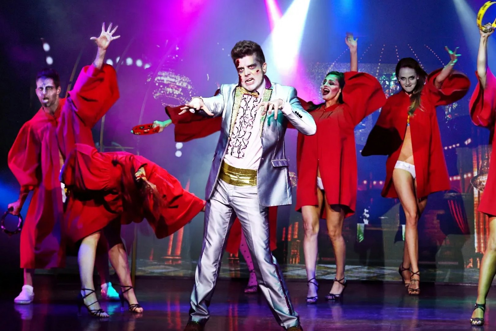 Performers in zombie makeup and costumes on stage during Zombie Burlesque show.