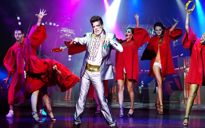 Performers in zombie makeup and costumes on stage during Zombie Burlesque show.