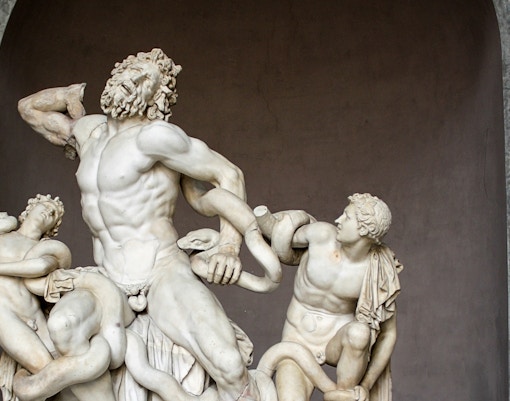 Laocoon and his Sons sculpture in Vatican Museums, Rome, depicting a dramatic mythological scene.
