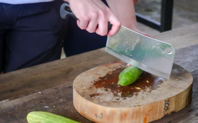 Chopping cucumber during meal preparation at Krabi Roaming Elephant Sanctuary.