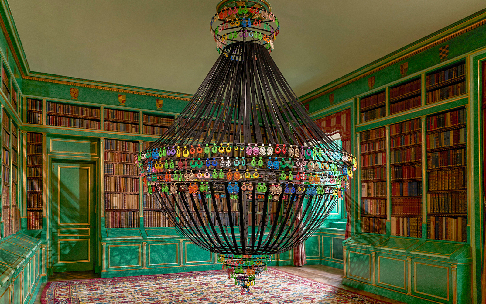 Chandelier in the library of Liria Palace, Madrid, surrounded by bookshelves.