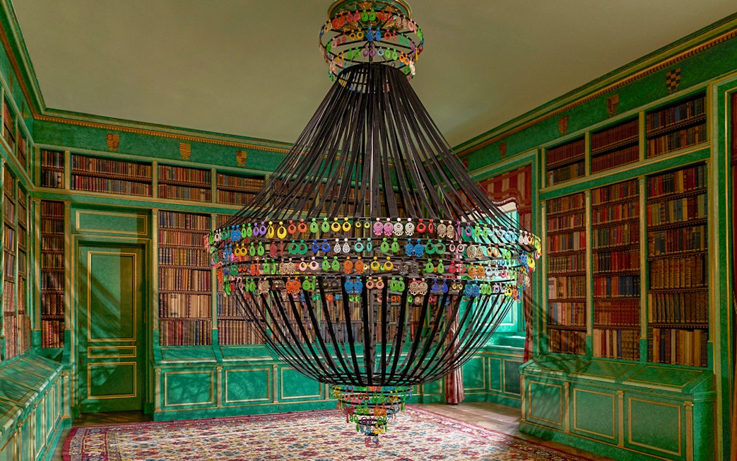 Chandelier in the library of Liria Palace, Madrid, surrounded by bookshelves.