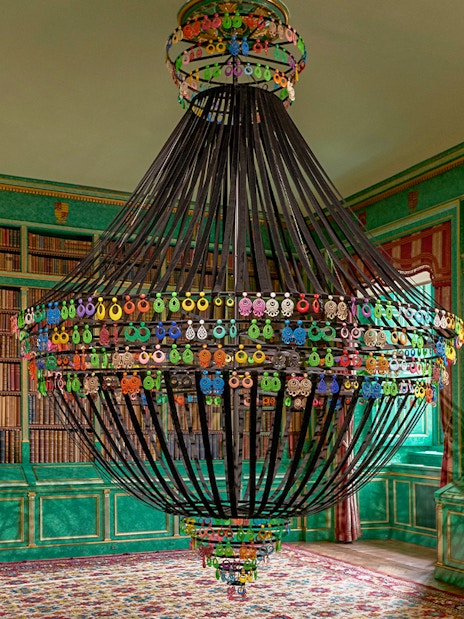 Chandelier in the library of Liria Palace, Madrid, surrounded by bookshelves.