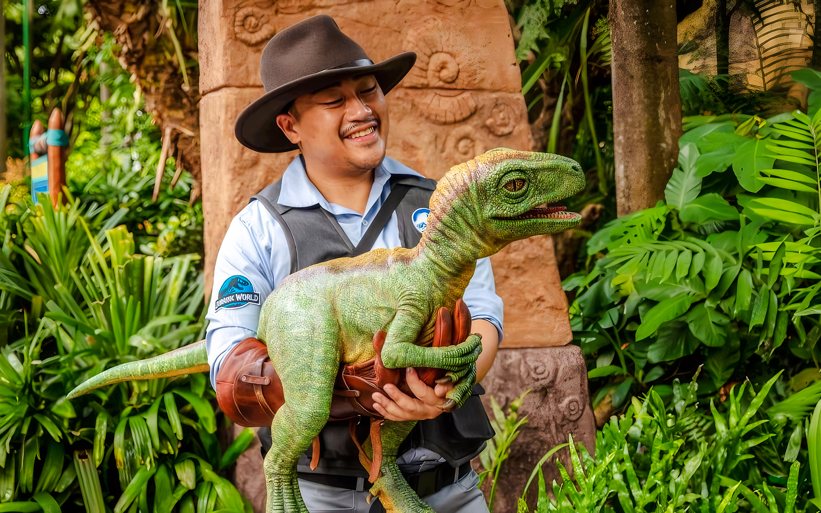Baby dinosaur with handler Kai in a park, engaging kids and families.