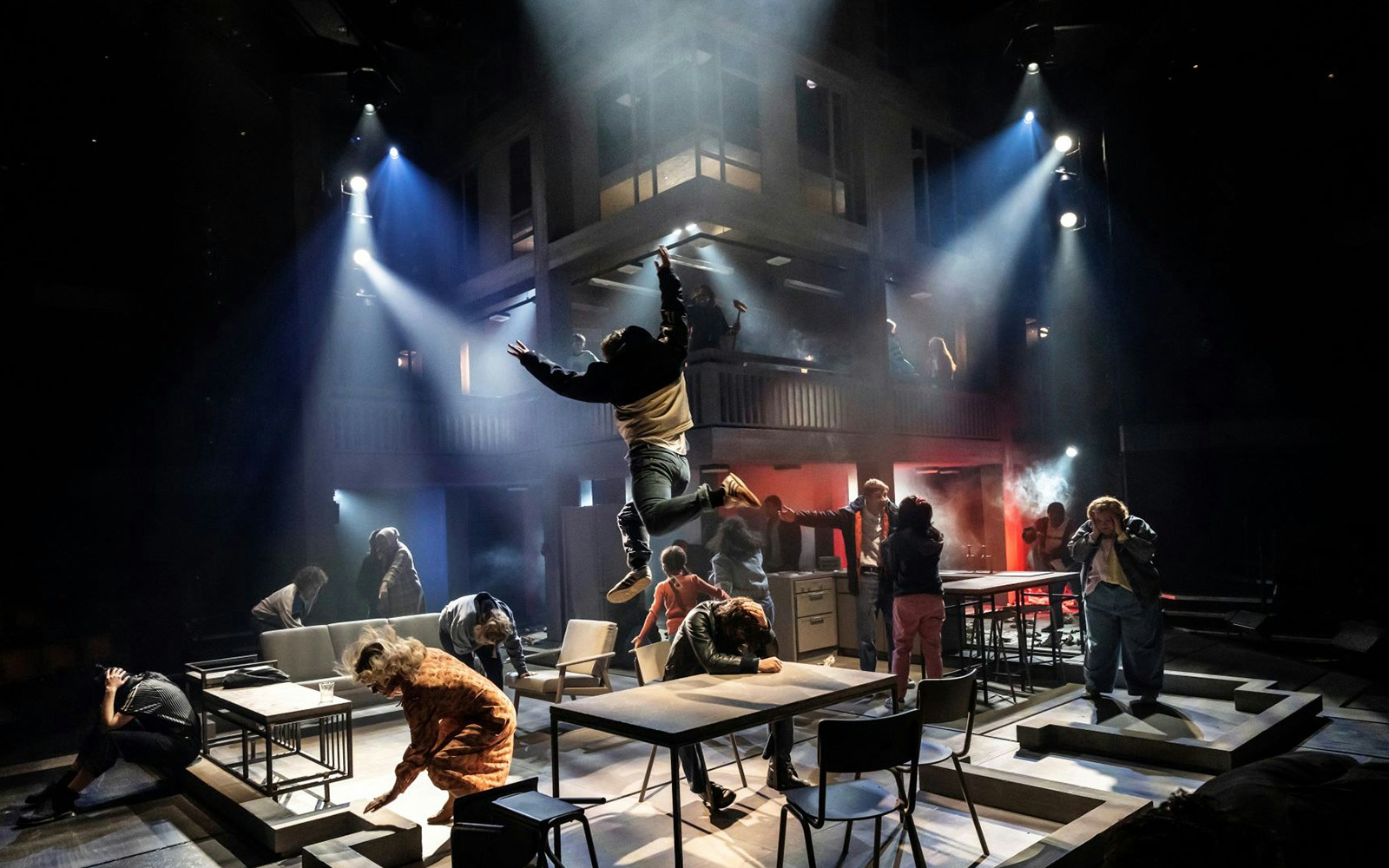 Performers on stage during "Standing At The Sky's Edge" musical, dramatic lighting and dynamic poses.