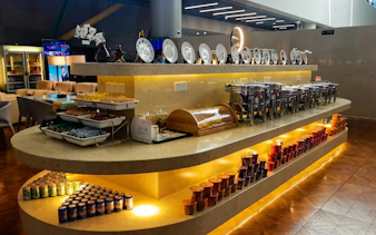 Buffet area in Shanghai Hongqiao International Airport Terminal 2 lounge with snacks and drinks.