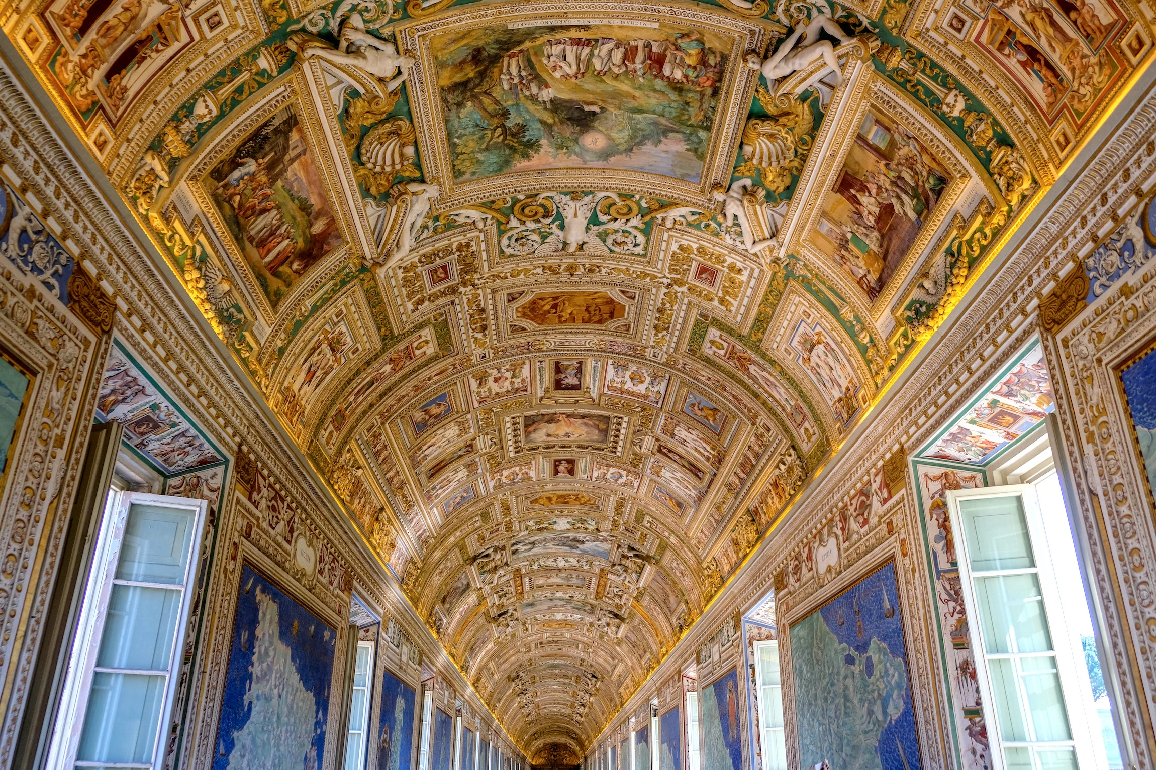 Vatican Museum Gallery of Maps with ornate ceiling and detailed frescoes.