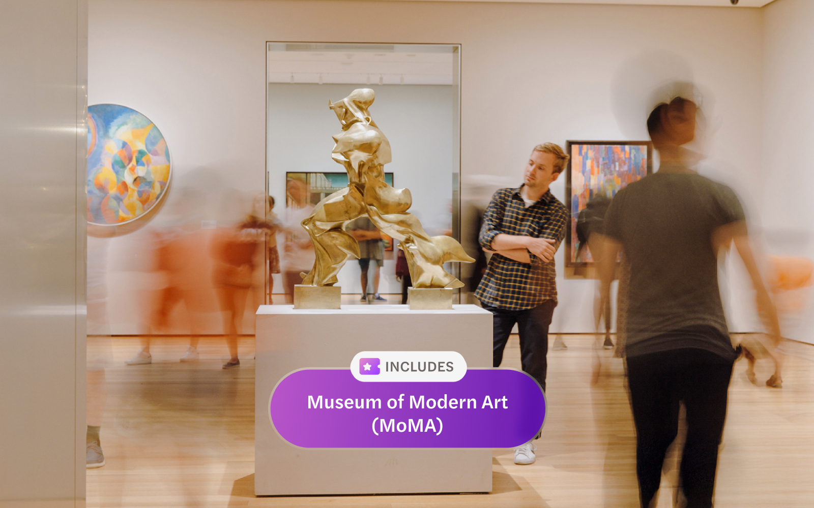 Sculpture display at Museum of Modern Art, New York, with visitors observing.