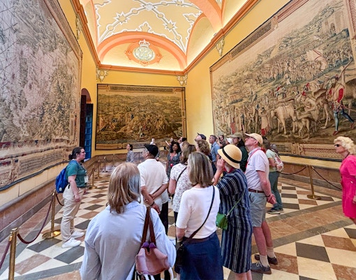 Seville Cathedral interior with guided tour group exploring historic architecture.