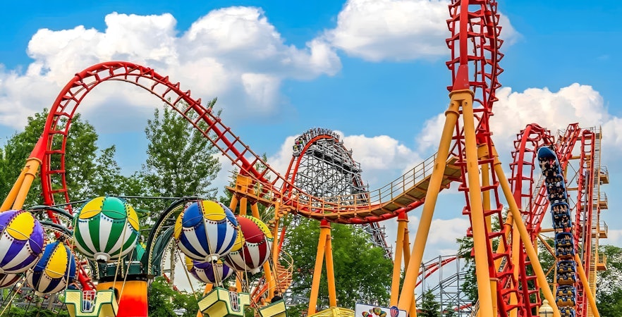 Flashback Rollercoaster at Six Flags New England with colorful loops and nearby balloon ride.