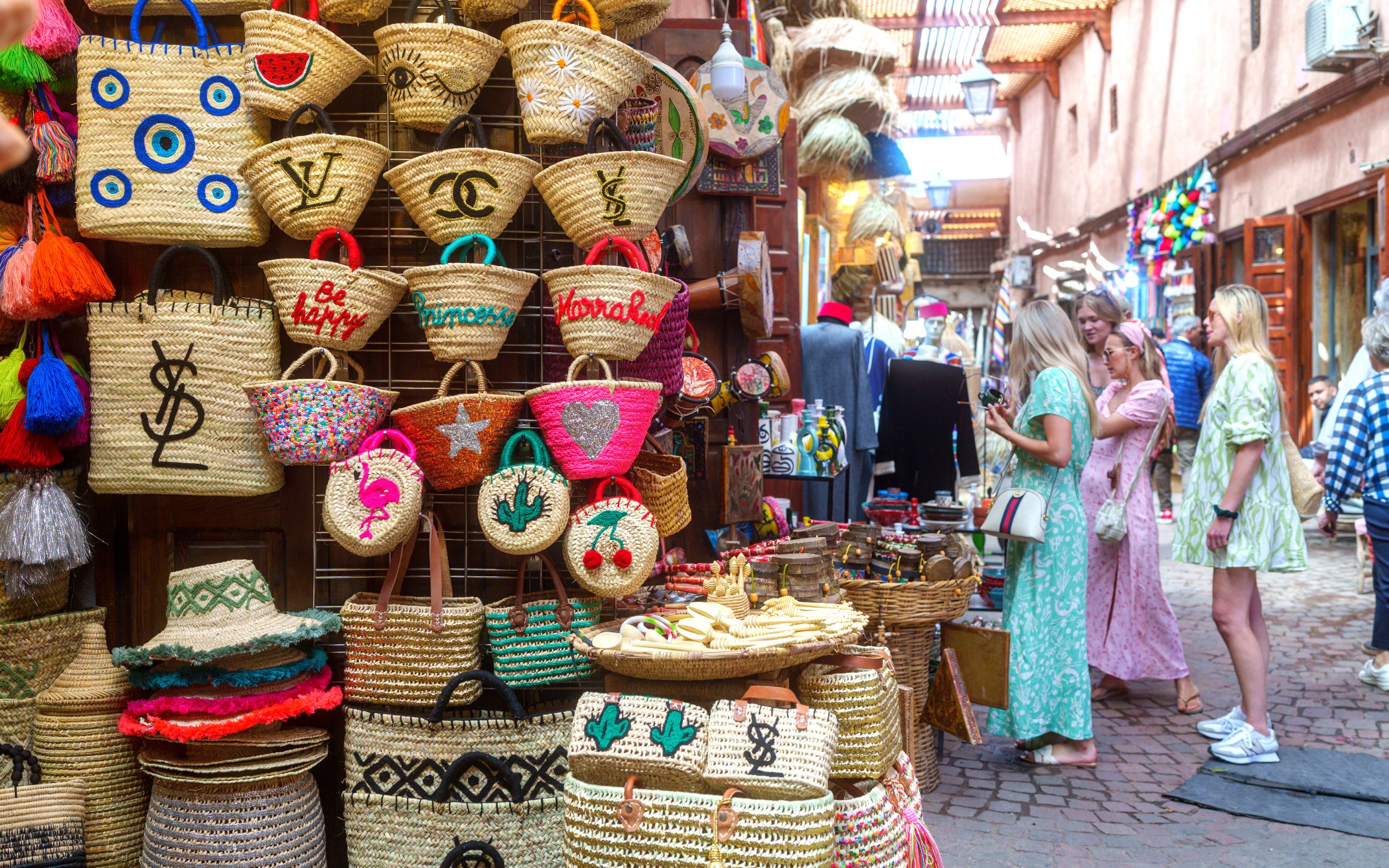 Woven baskets and tourists in Marrakech souk during guided tour.
