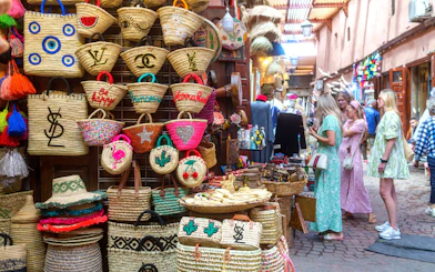 Woven baskets and tourists in Marrakech souk during guided tour.