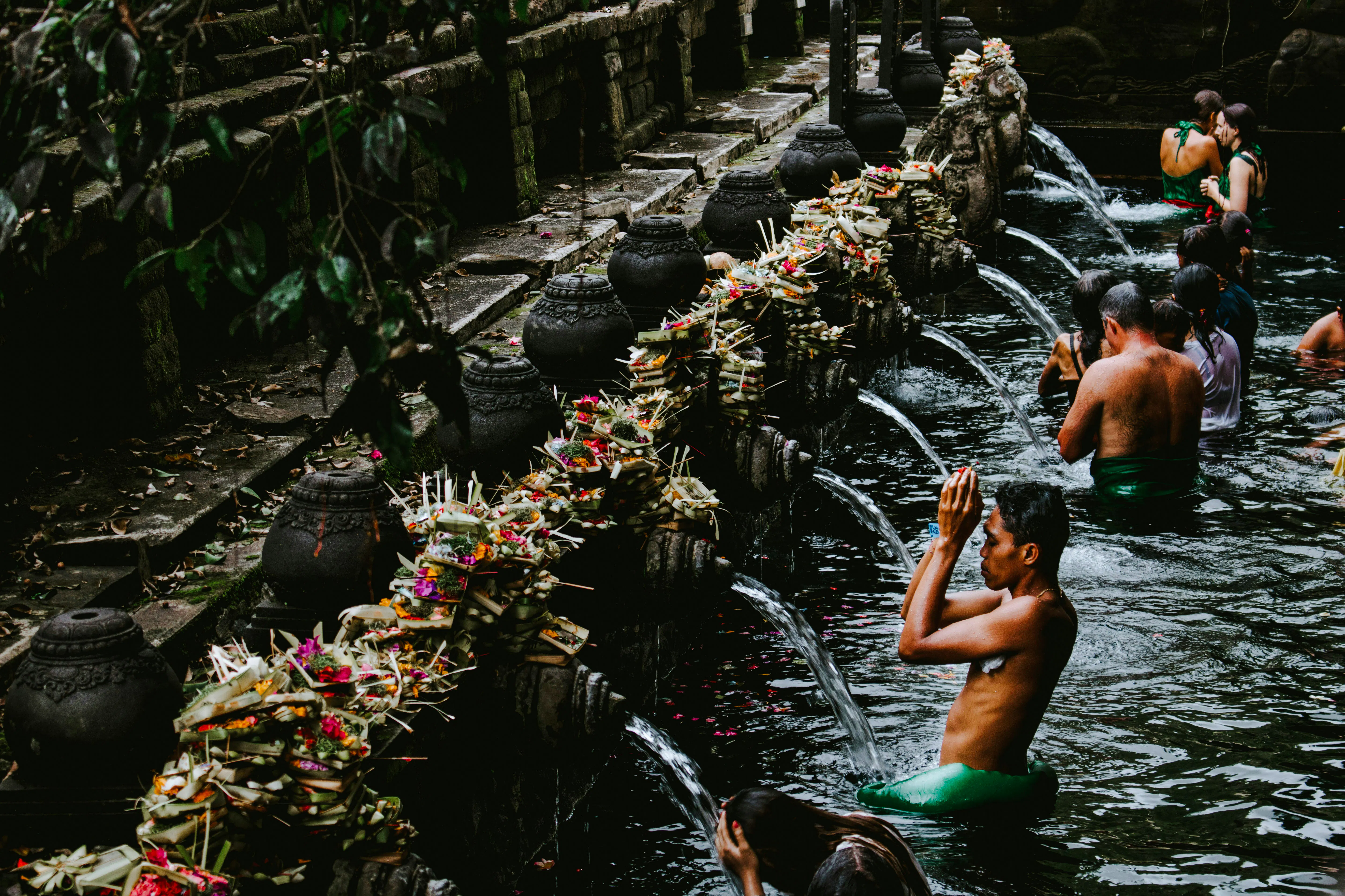 Visitors participating in water purification ritual at Tirta Empul Temple, Bali.