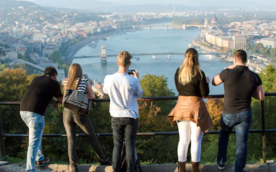 Tourists overlooking the Danube River and Chain Bridge in Budapest.