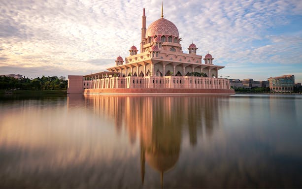 Putra Mosque reflecting in the lake at sunset, Kuala Lumpur.