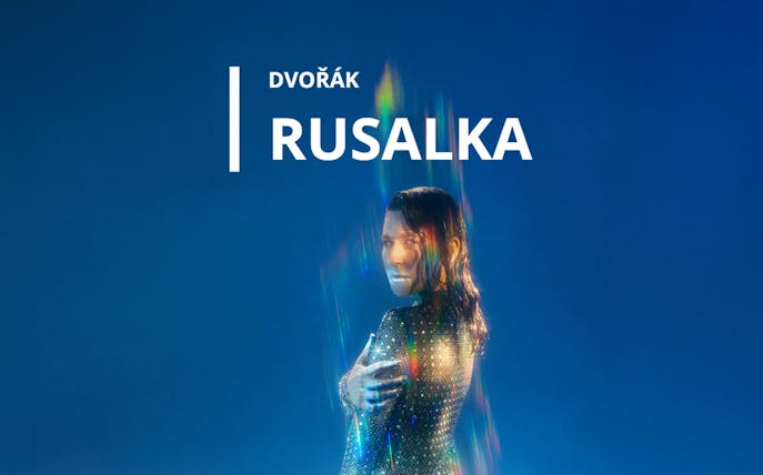 Rusalka opera promotional image with a figure in shimmering attire against a blue background.