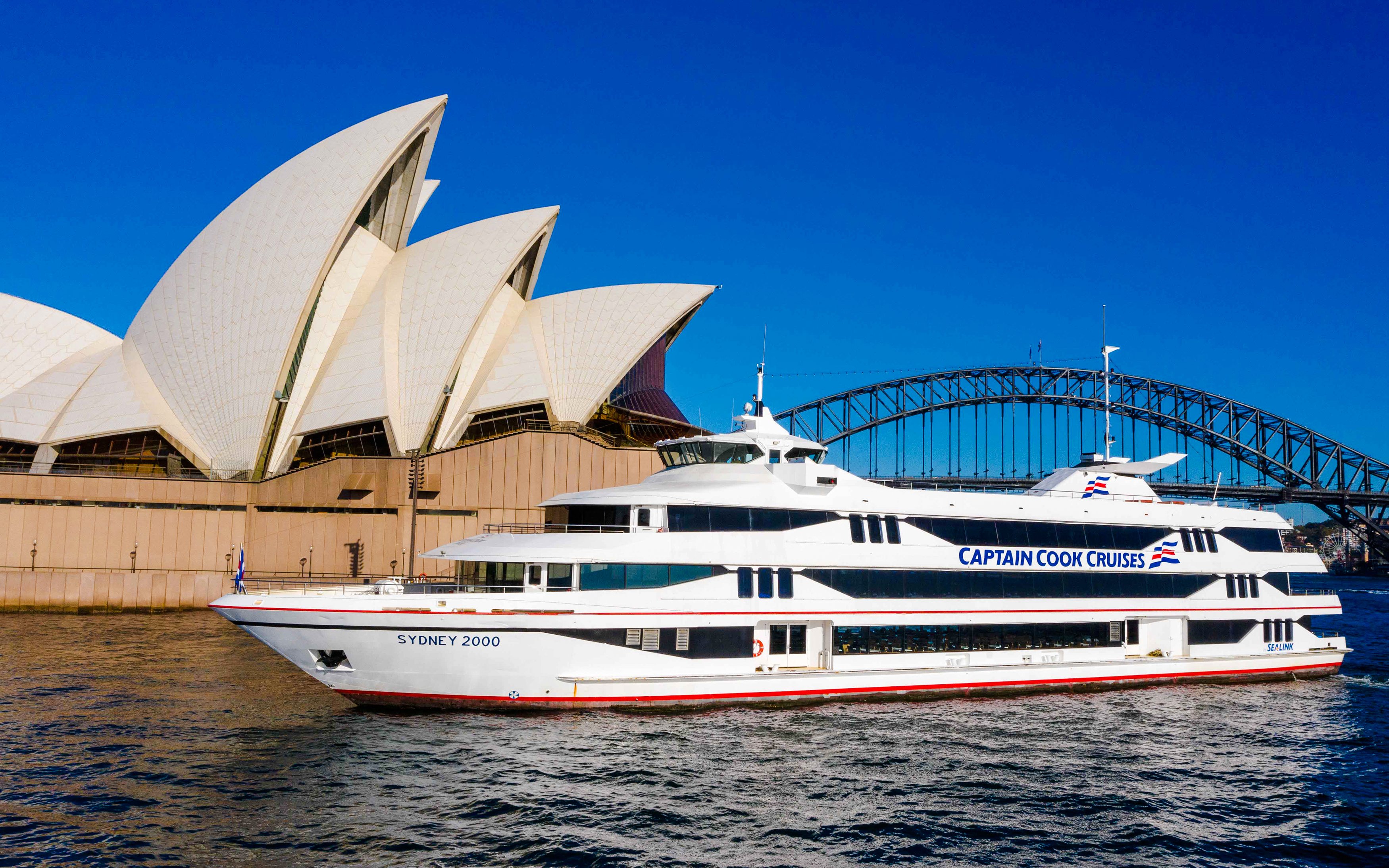 Sydney Opera House and Harbour Bridge with Captain Cook cruise ship.