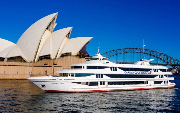 Sydney Opera House and Harbour Bridge with Captain Cook cruise ship.