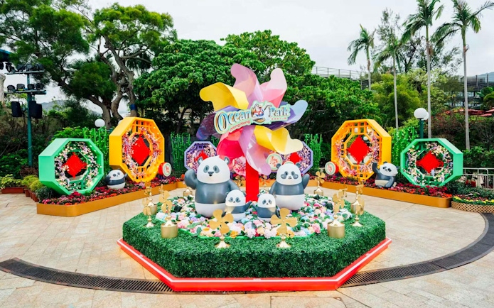 Giant panda figurines at Ocean Park Hong Kong surrounded by colorful decorations.