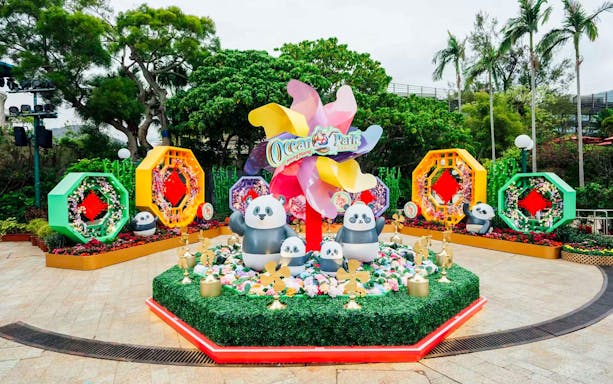 Giant panda figurines at Ocean Park Hong Kong surrounded by colorful decorations.