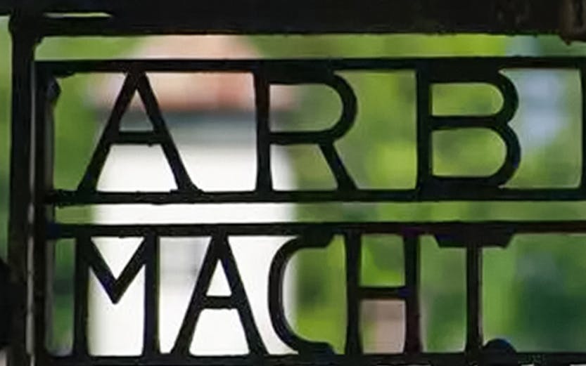 Entrance gate with "Arbeit Macht Frei" at Dachau Concentration Camp, Germany.