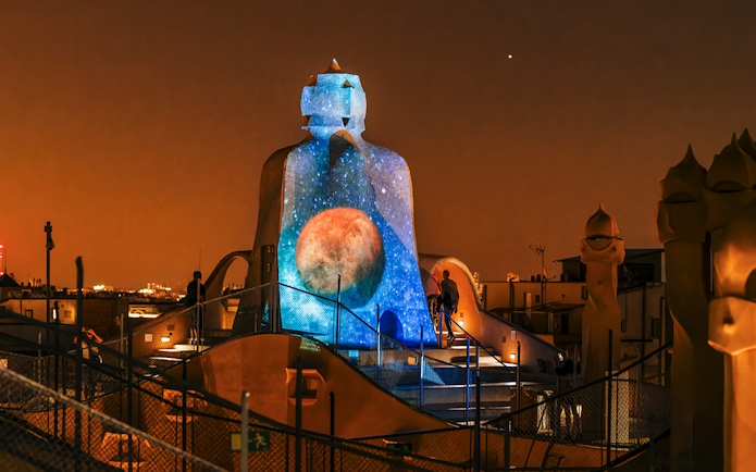 Casa Mila rooftop with night projection during La Pedrera Night Experience in Barcelona.