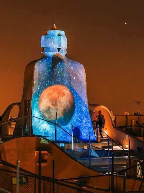 Casa Mila rooftop with night projection during La Pedrera Night Experience in Barcelona.
