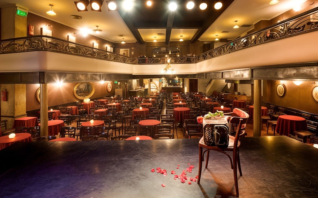 El Viejo Almacén Tango Show venue with stage view and red table settings.