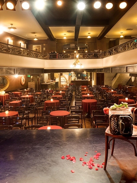El Viejo Almacén Tango Show venue with stage view and red table settings.