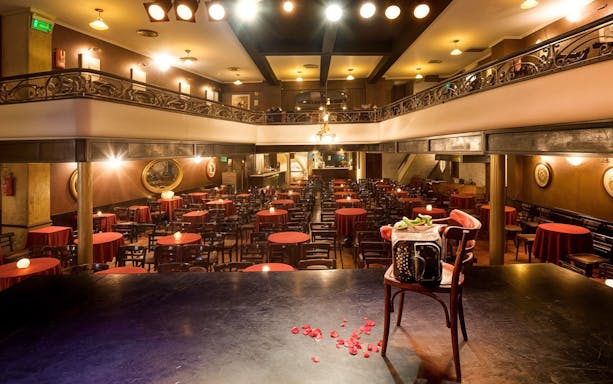 El Viejo Almacén Tango Show venue with stage view and red table settings.