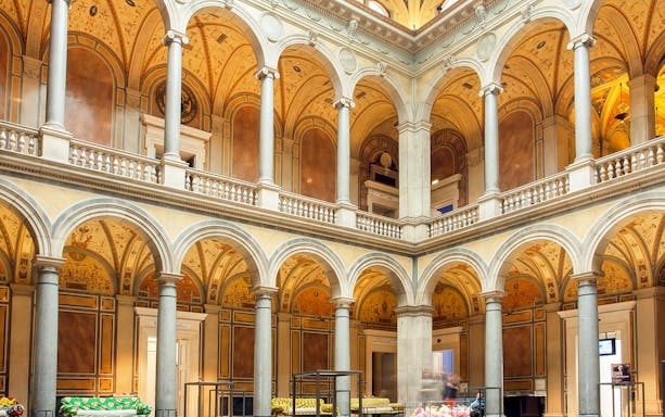 Interior of MAK Museum of Applied Arts in Vienna with ornate arches and columns.