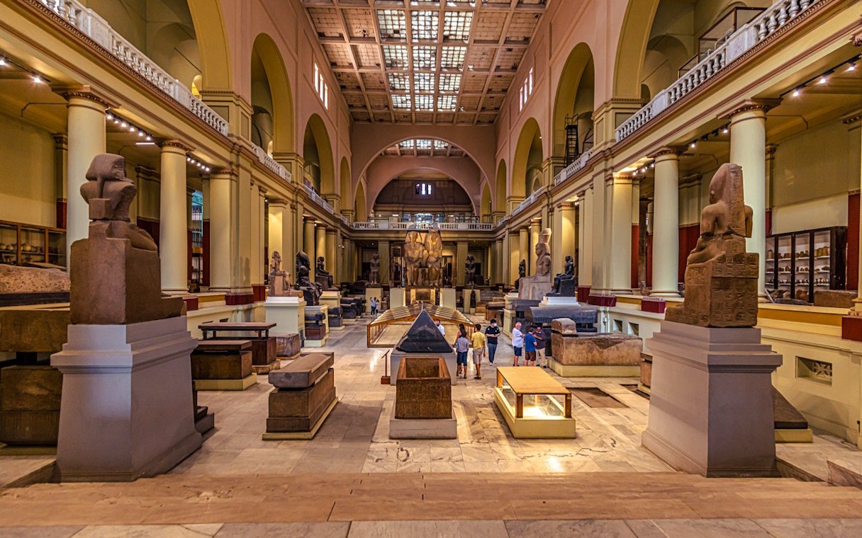 Interior of the Egyptian Museum in Cairo with ancient artifacts and statues, related to the Giza Complex.