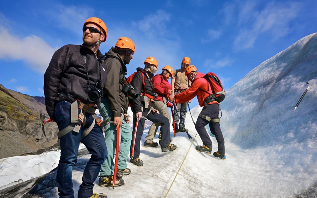 Guests hiking and ice climbing on a glacier in Skaftafell, Iceland.