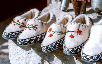 Traditional Albanian slippers with floral embroidery at Ethnographic Museum, Kruja Castle, Albania.