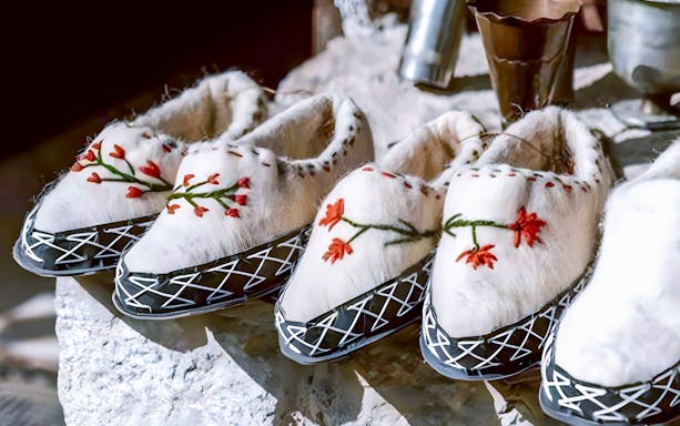 Traditional Albanian slippers with floral embroidery at Ethnographic Museum, Kruja Castle, Albania.