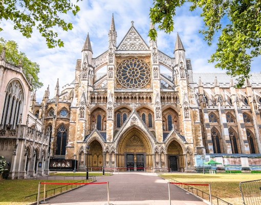 Westminster Abbey exterior with Gothic architecture and rose window in London.