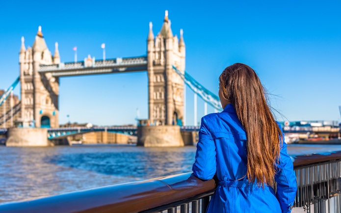 Woman overlooking Tower Bridge in London.