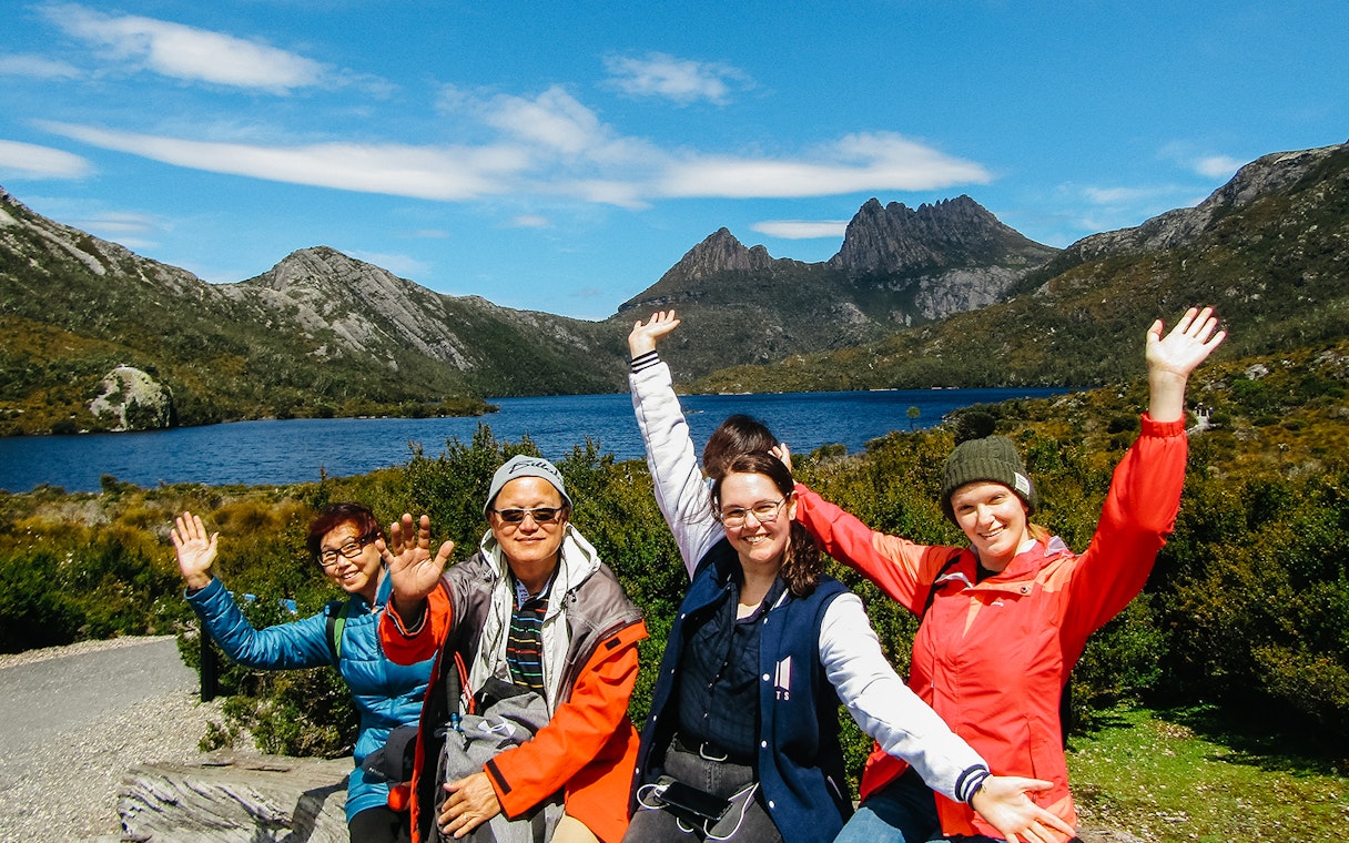Group of tourists enjoying a guided walking tour at Cradle Mountain National Park.