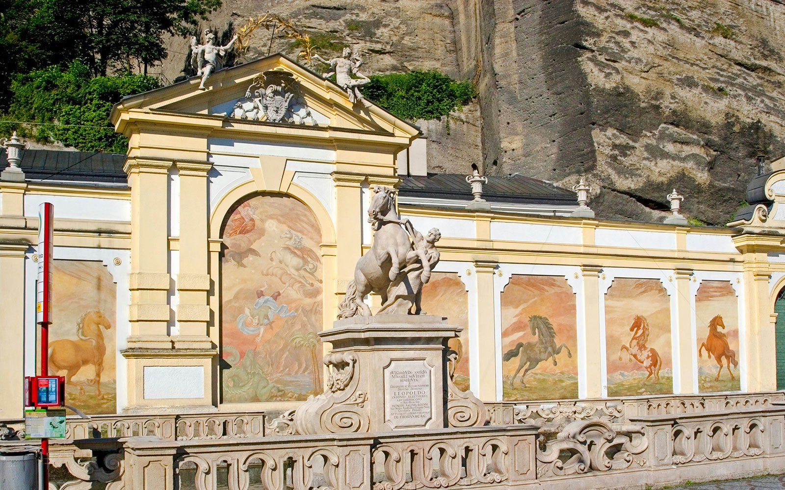 Pferdeschwemme fountain with horse statue and murals in Salzburg, Austria.