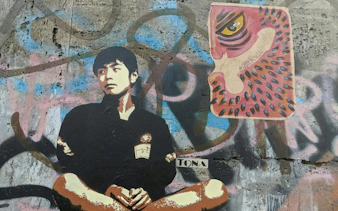 Street art mural featuring a seated figure and abstract design in Bucharest.