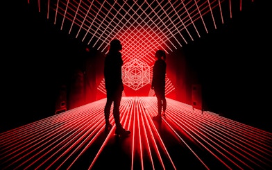 Tourists surrounded by red laser lights at Amaze Amsterdam.