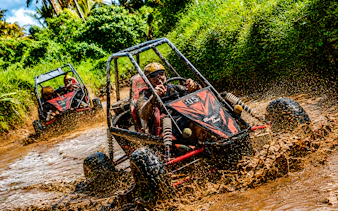 Buggy driving through muddy jungle track in Ubud, Bali.