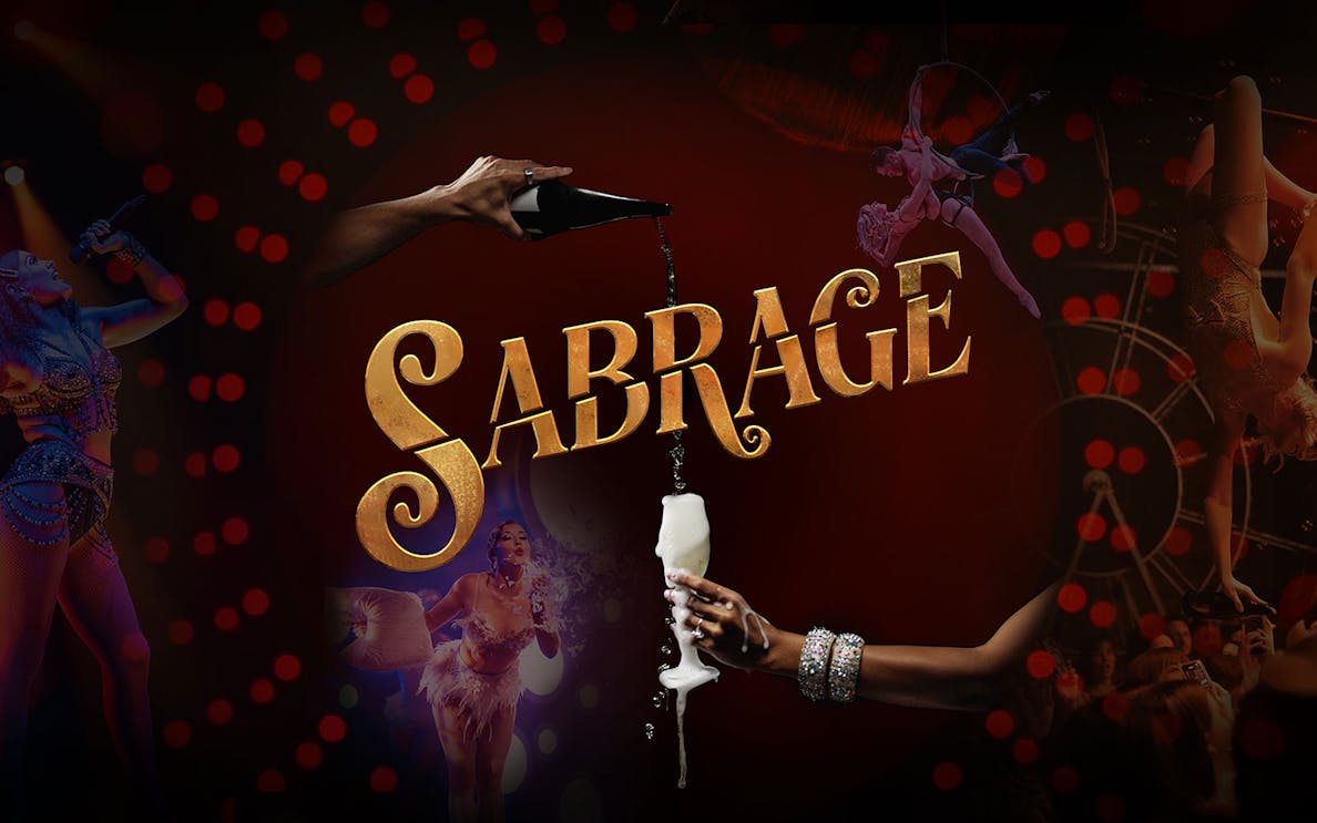 Sabrage event with champagne pouring and performers in vibrant costumes.